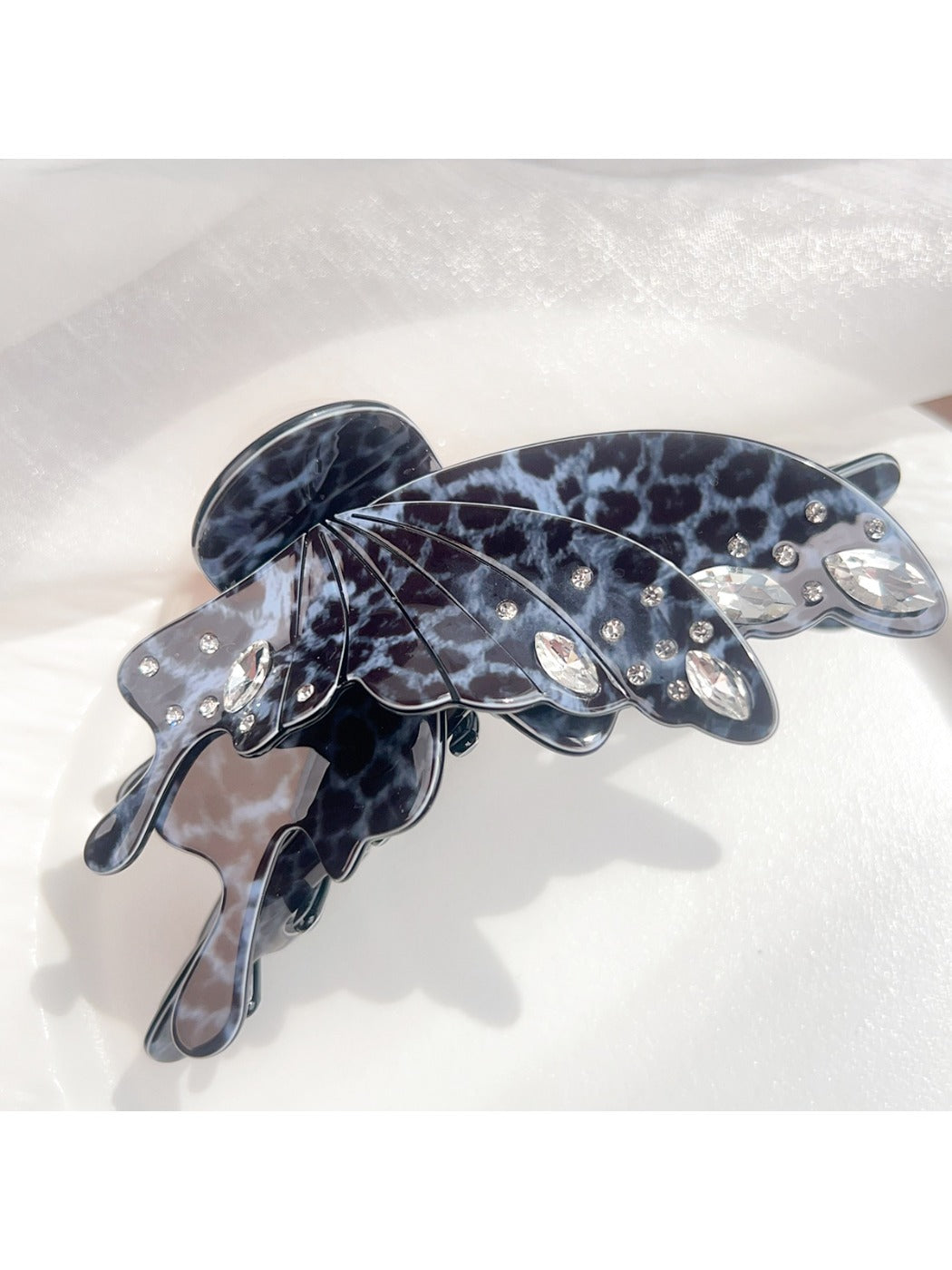 Beau leopard print butterfly claw clip displayed with packaging
