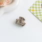 Beau hair clip with clasp open to display fastening details