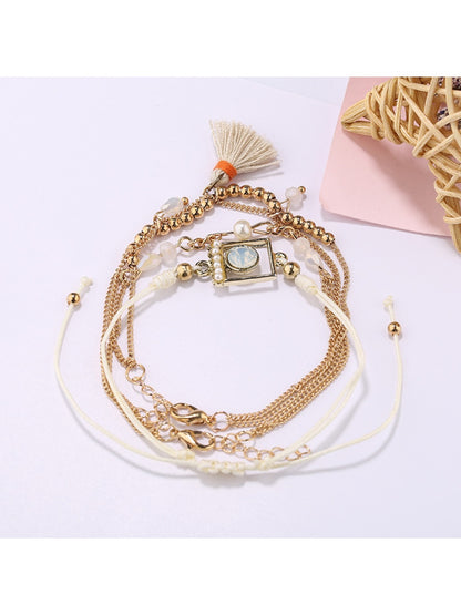 Side view of Lovra bracelet showing small beads and tassel pendant details