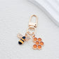 Bee and honeycomb keychain hanging from a set of keys