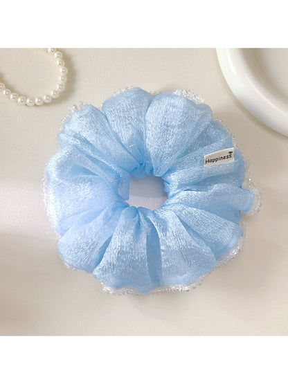 Close-up of Gifty ruched scrunchie showing fabric texture and elastic band