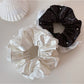Gifty lively lightweight scrunchie with white polka dots on a pastel pink fabric