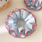 Top view of Gifty polka dot scrunchie highlighting ruffle details