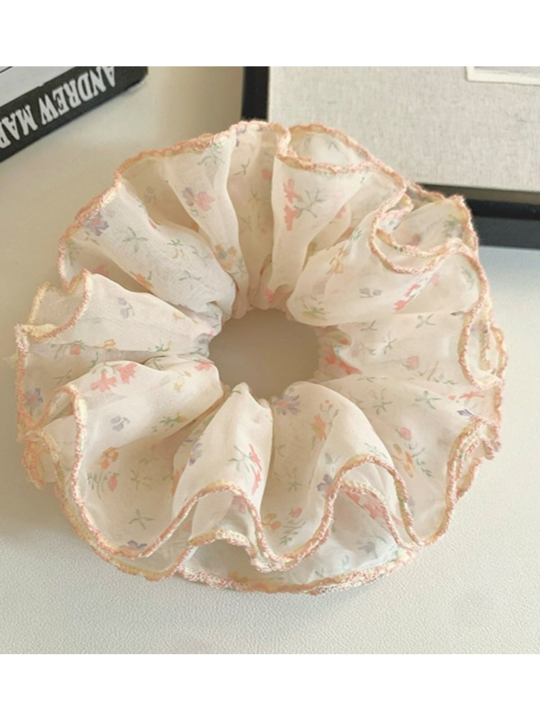 Gifty floral print scrunchie styled on a wrist as an accessory