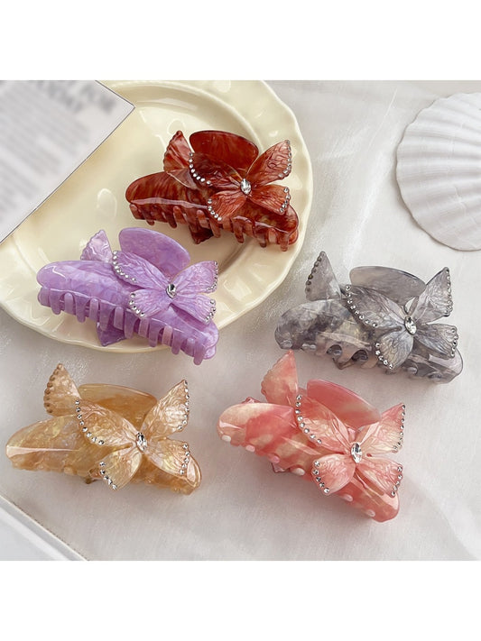 Beau colorful hair claw clip with butterfly decorations on a white background