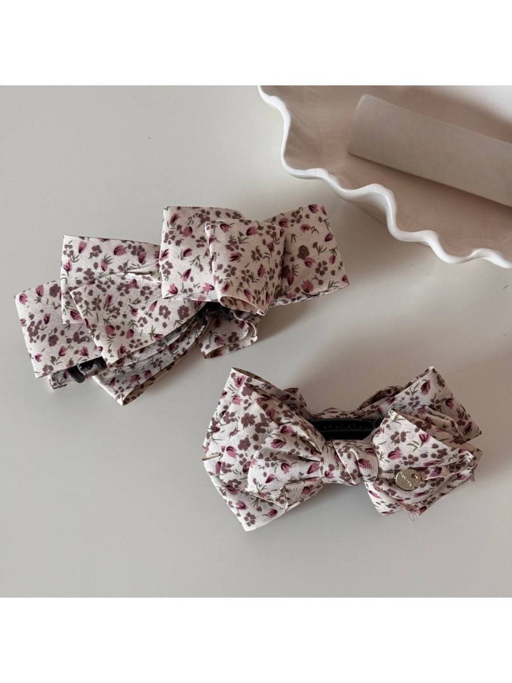 Side view of Beau small floral bow hair clip with metal clip attachment