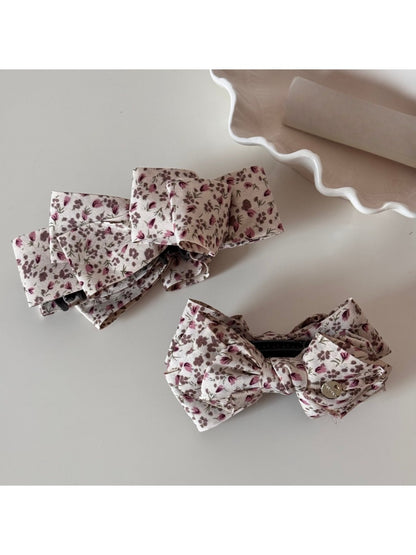 Side view of Beau small floral bow hair clip with metal clip attachment