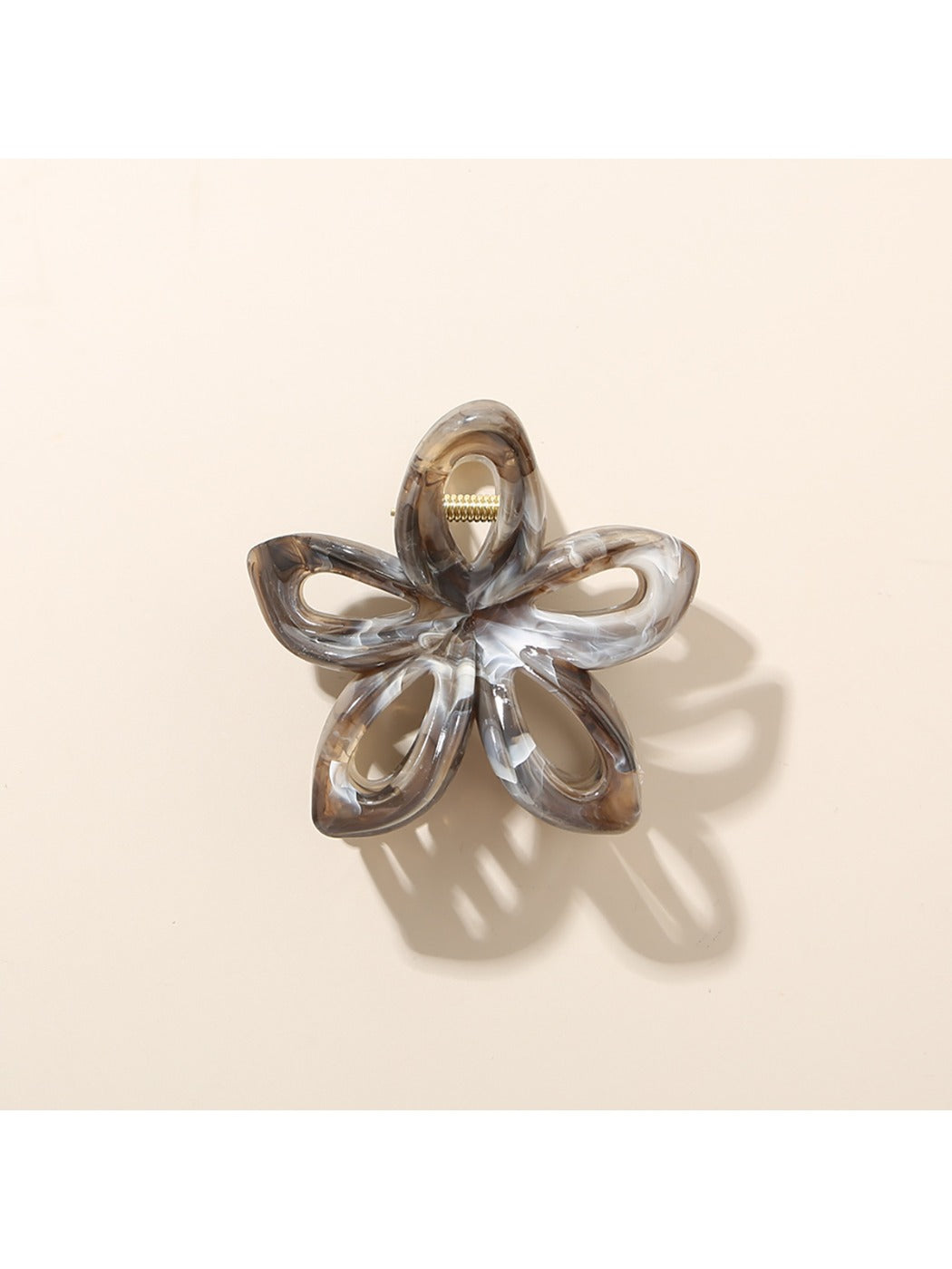 Beau openwork flower hair clip with multicolor petals against a light background
