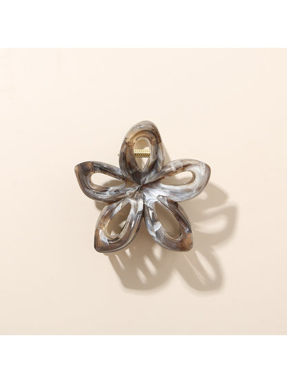 Beau openwork flower hair clip with multicolor petals against a light background