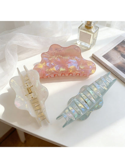Beau holographic claw clip open, displaying inner teeth and hinge