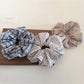 Side view of Gifty plaid scrunchie showing fabric texture and elastic band