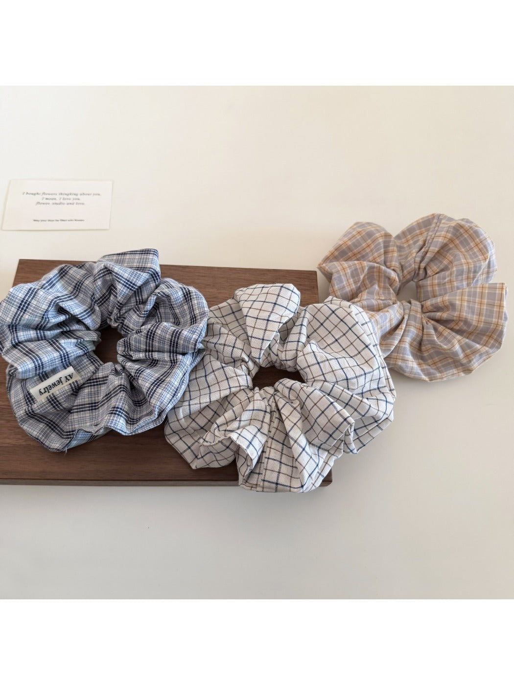 Side view of Gifty plaid scrunchie showing fabric texture and elastic band