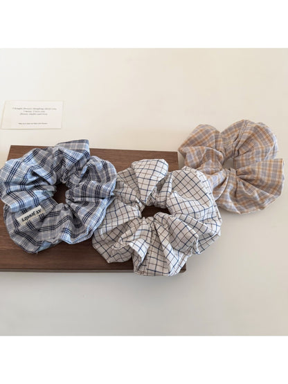 Side view of Gifty plaid scrunchie showing fabric texture and elastic band