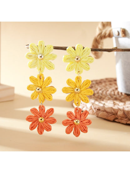 Close-up of earring hooks attached to colorful flower shaped drops