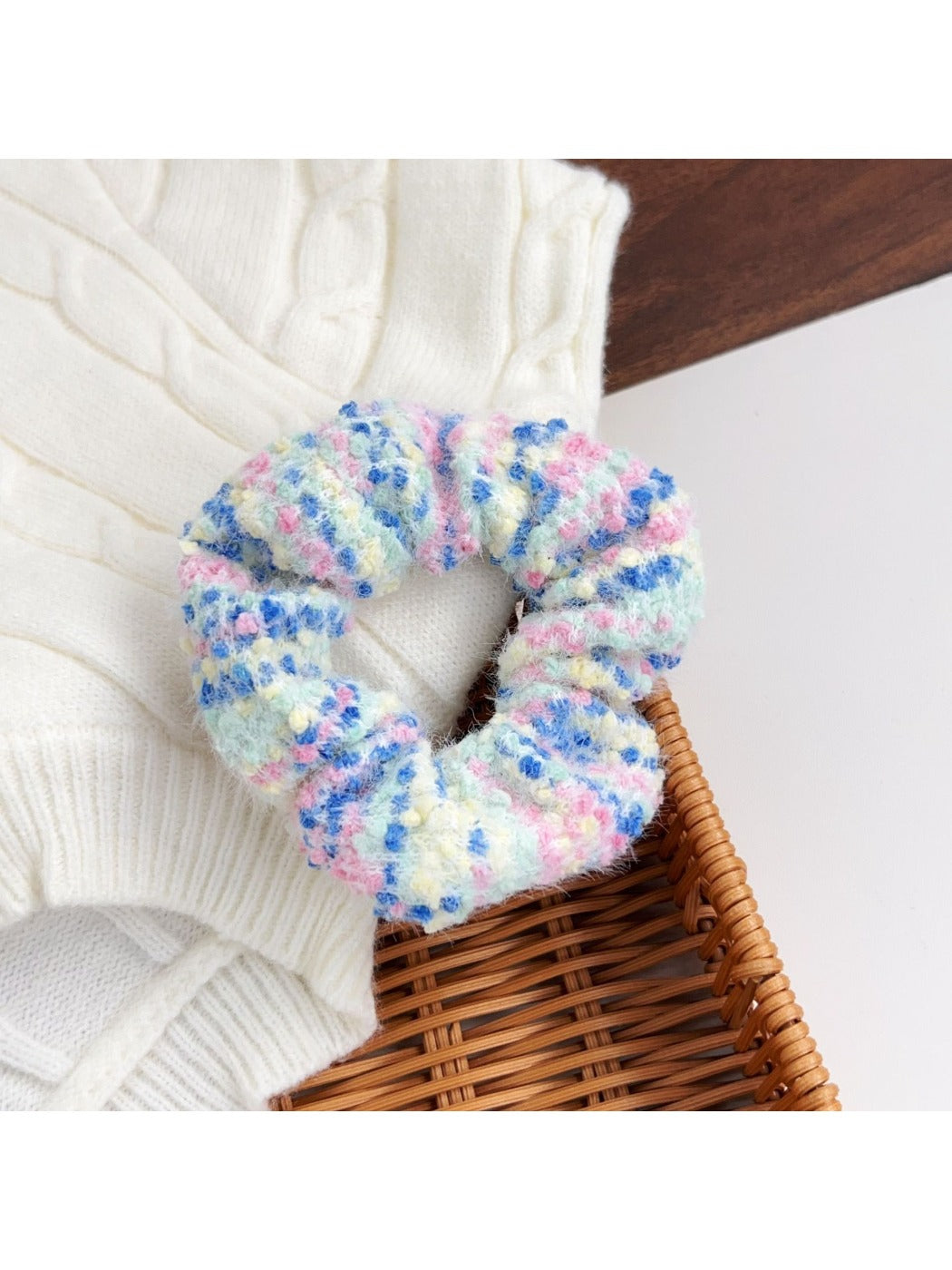 Model wearing a colorful scrunchie in her hair with matching headbands