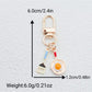 Keypus keychain showing both fried egg and spatula charms attached to a metal ring