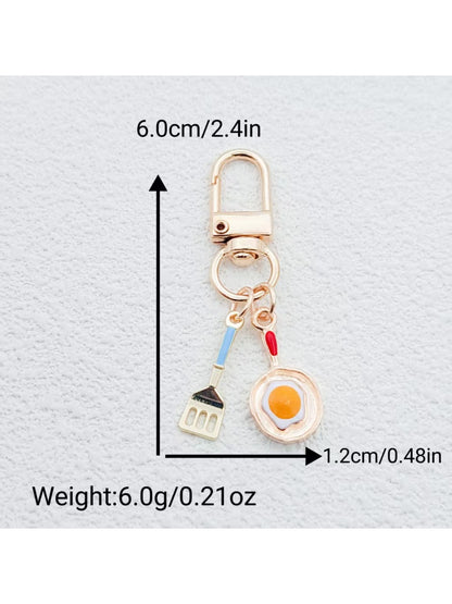 Keypus keychain showing both fried egg and spatula charms attached to a metal ring