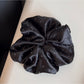 Gifty rhinestone decor satin scrunchie displayed with matching accessories