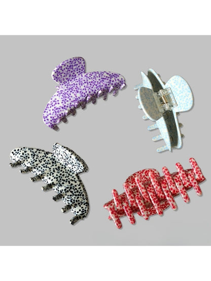 Top view of Beau Irregular Polka Dot Claw Clip with irregular white dots