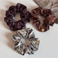 Side view of Gifty printed scrunchie highlighting fabric texture and elastic band