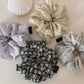 Gifty scrunchie worn on a wrist, showcasing its size and daisy design