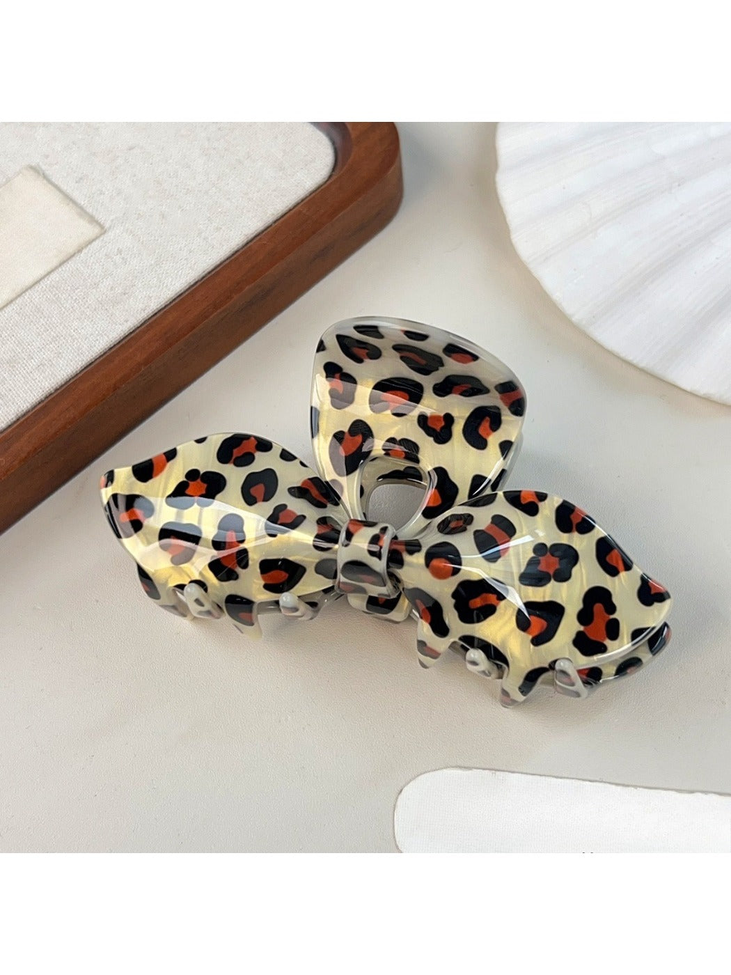 Top view of Beau leopard print bow-shaped claw clip