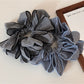 Gifty classic checked pattern scrunchie in black and white fabric close-up