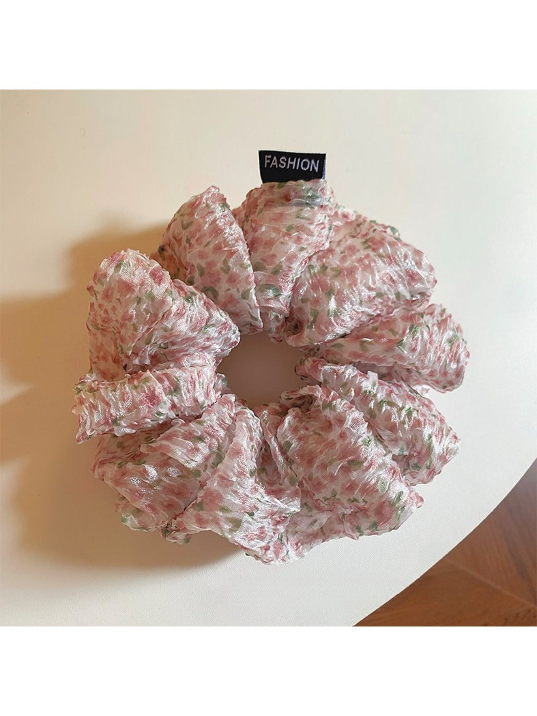 Pink floral tulle scrunchie held in hand showing size and detail