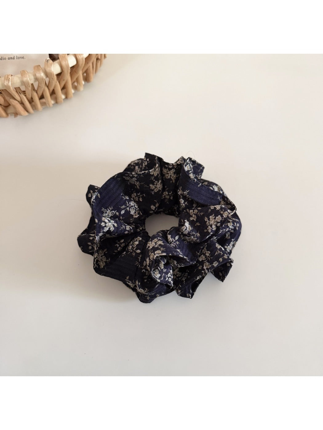 Model wearing Gifty vintage floral ruffled scrunchie in loose hair bun