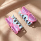 Side view of Beau clear acrylic glasses-shaped claw clip on white background
