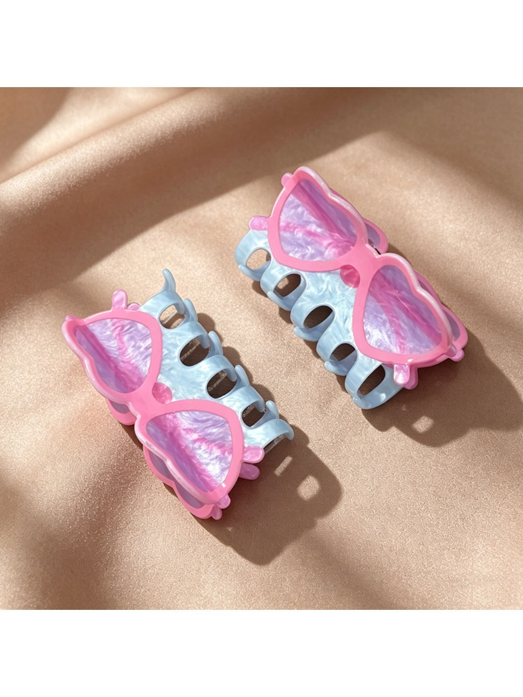 Side view of Beau clear acrylic glasses-shaped claw clip on white background