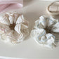 Close-up of Gifty lace trim tiny floral scrunchie with pink and white flowers