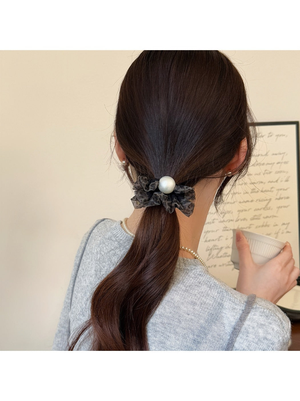 Multiple hair ties displayed on a white surface showing plaid and polka dot designs