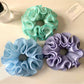 Side view of Gifty solid color ruffle scrunchie highlighting the ruffle detail