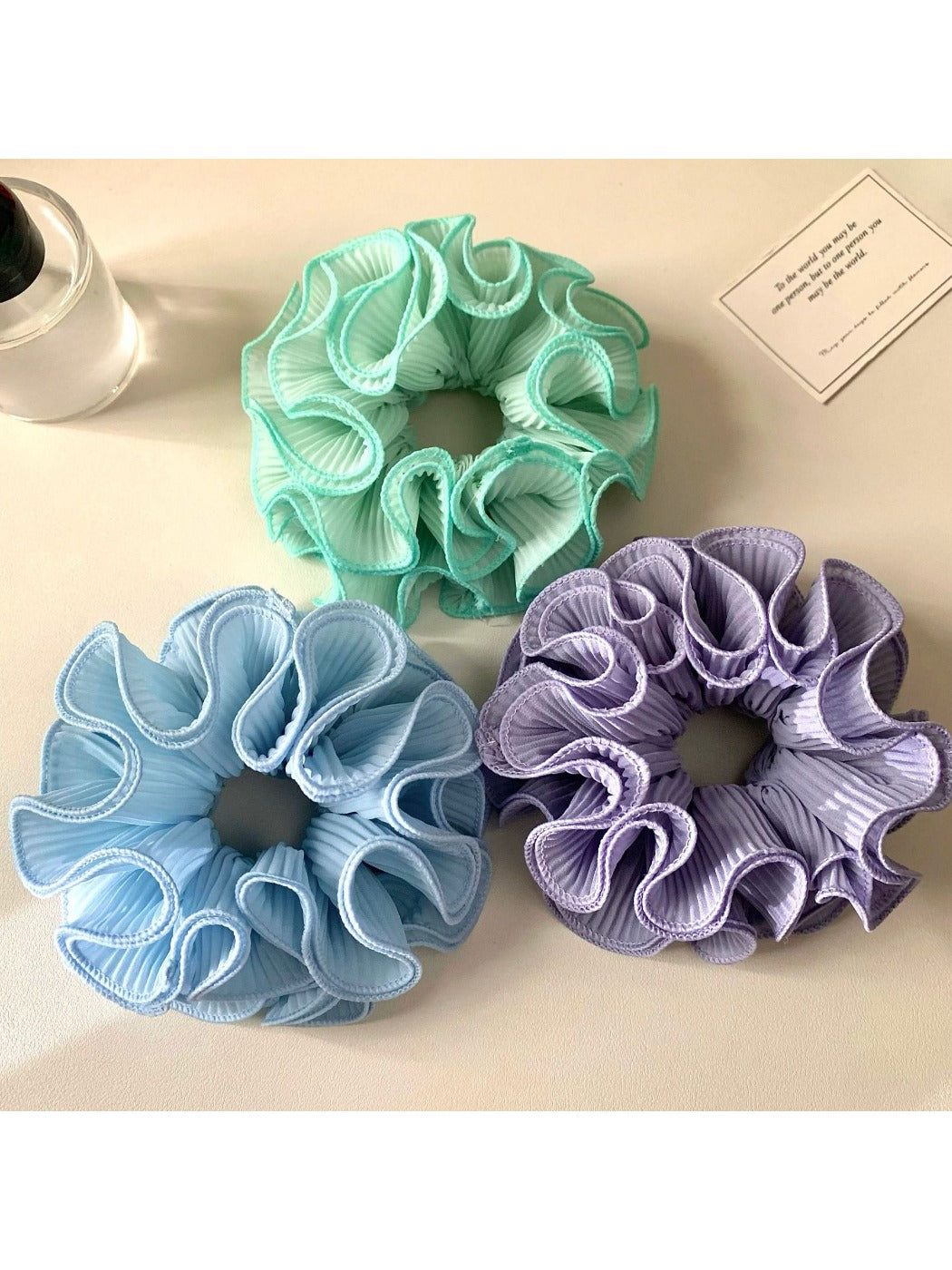 Side view of Gifty solid color ruffle scrunchie highlighting the ruffle detail