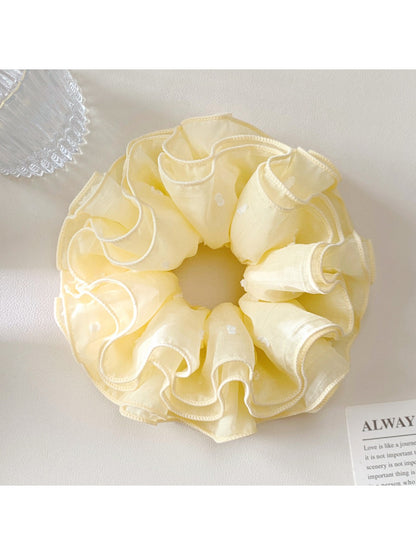 Gifty scrunchie worn on wrist as a stylish accessory in pastel pink color