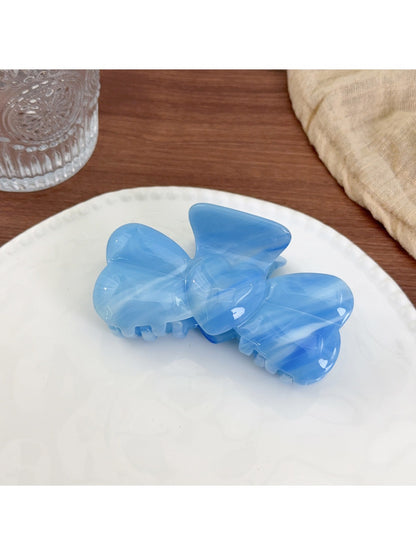 Side view of Beau bow hair claw clip highlighting curved design
