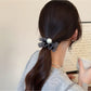 Polka dot hair tie in black with white dots on elastic band