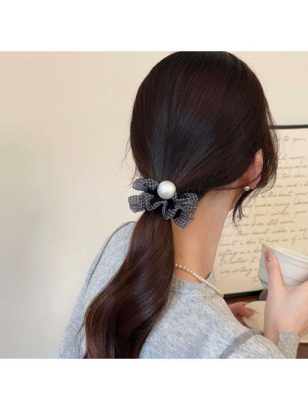 Polka dot hair tie in black with white dots on elastic band