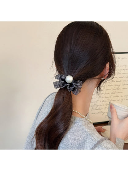 Polka dot hair tie in black with white dots on elastic band