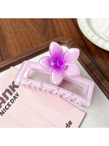 Beau square ombre flower shaped claw clip shown from bottom angle focusing on clasp details