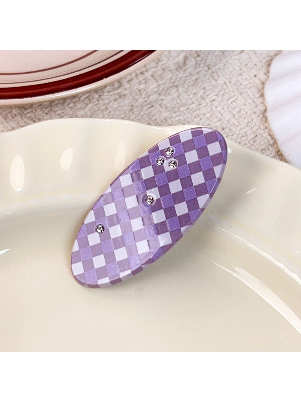 Purple plaid hair claw clip clipped into brown hair