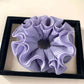 Gifty minimalist solid color ruffle scrunchie folded neatly on a flat surface