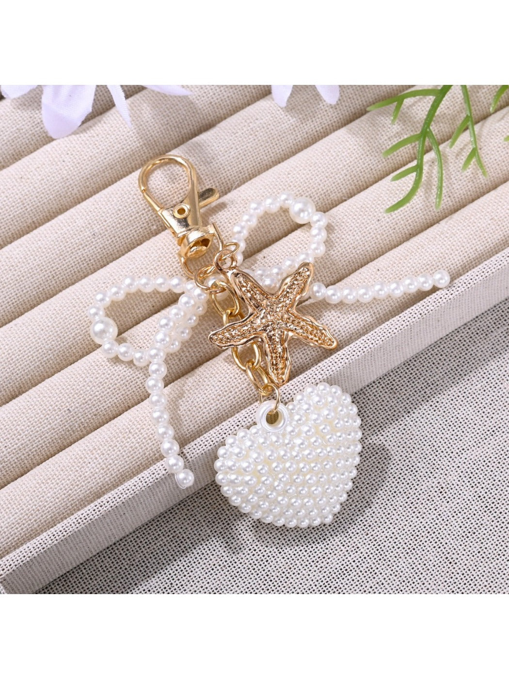 Pink bow heart shaped keychain with gold ring isolated on white background
