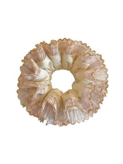Multiple Gifty satin lace trim scrunchies in various pastel colors arranged together