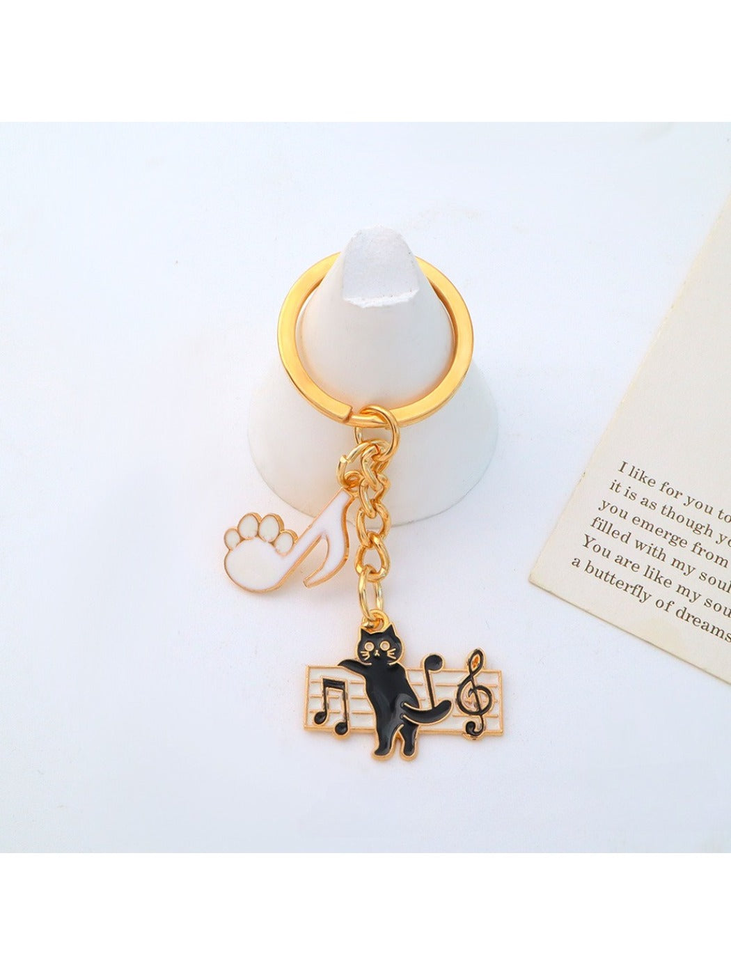 Close-up of piano keys on cartoon cat keychain with glossy finish
