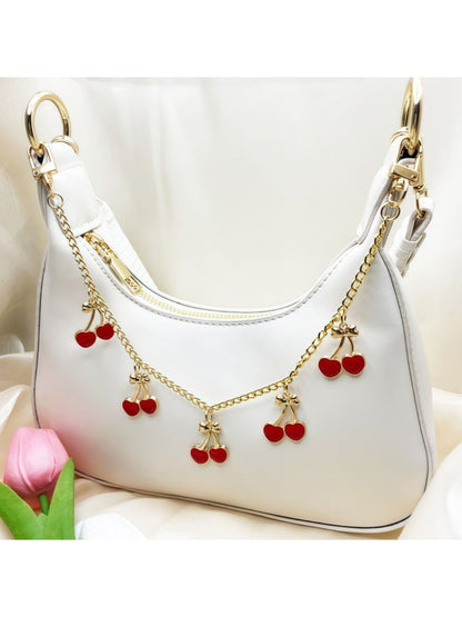 Side view of the cherry charm highlighting its slim profile and glossy finish
