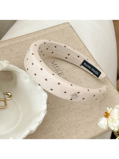 Top view of the star hairband highlighting the star shape and smooth band finish