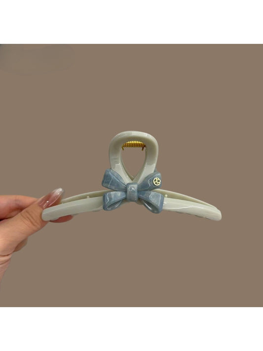 Blue acetate bow-shaped hair clip with a glossy finish