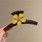 Beau minimalist flower-shaped claw clip in beige with soft shadows